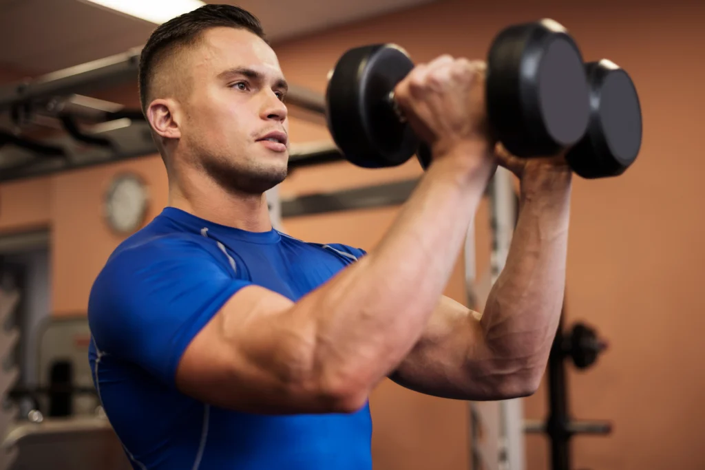 Muscular man lifting weights, emphasizing the importance of bodybuilding for men’s health and strength.