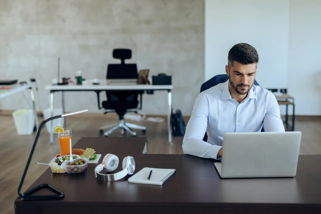 young-businessman-working-laptop-his-office-desk