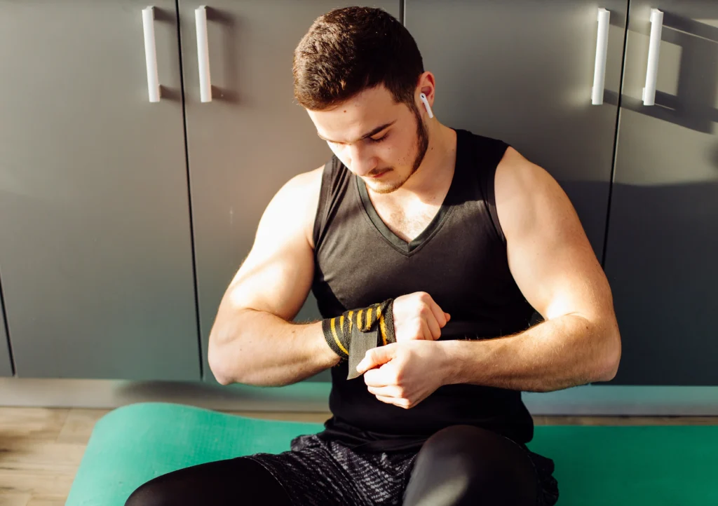 Young man doing sports exercises at home