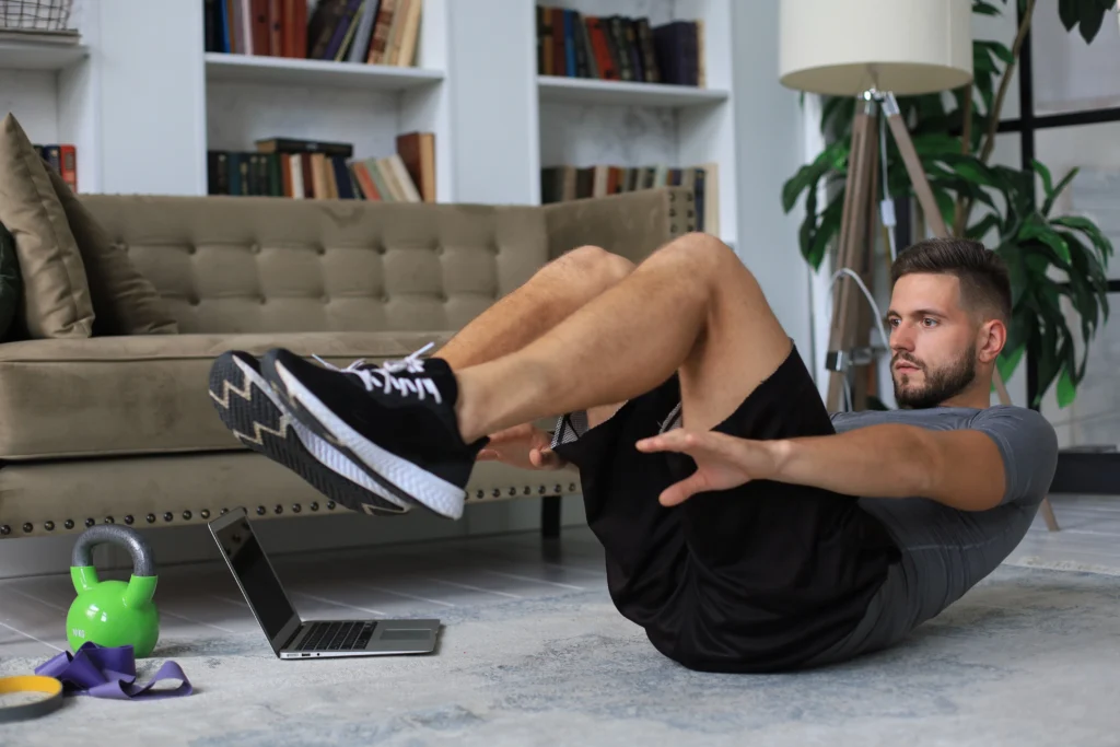 handsome-man-doing-abs-exercises-home-quarantine-concept-healthy-life