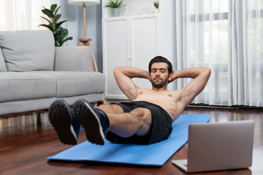 athletic-sporty-man-doing-crunch-fitness-mat-while-follow-online-home-workout-exercise-instruction-fit-physique-healthy-sport-lifestyle-home-online-gaiety-home-exercise-video